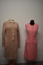 A 1960s tailored pink linen day dress with white stitching and a 1960s knitted green and pink