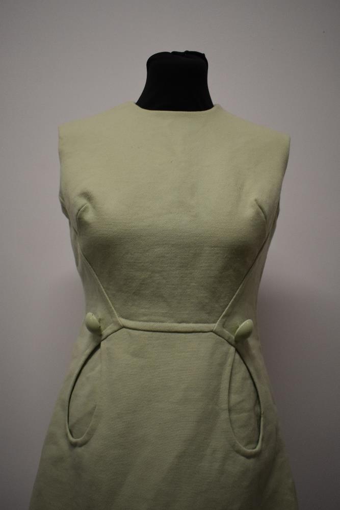 A mint green 1960s mini dress, with looped pockets and large button detail. - Image 2 of 8