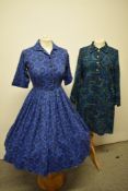 A 1950s full skirted cotton day dress, having brilliant novelty medallion print on cobalt blue