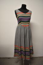 A 1950s light grey fine wool day dress, having colourful embroidery to hem and bodice, with fairly