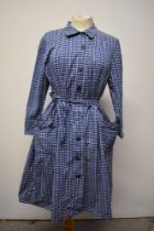 A 1950s blue and white cotton shirt waister dress, having patch pockets to skirt and tie belt to