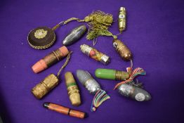 A collection of vintage needle, thimble and spool cases, also included is a tape measure.