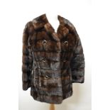 A mahogany coloured mink coat, having faux double breasted button detail and Capstick and Hamer