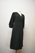 A 1930s bottle green day dress, having ladder work to sleeves and bodice, with cream twist detail to