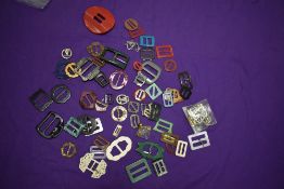 A collection of vintage and antique belt buckles.