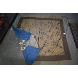 An unusual antique bed throw, having unusual braided metal border to one side and blue and gold