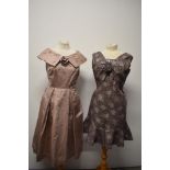 A dusty pink 1950s evening dress having shawl collar,side metal zip and pleated skirt and a 1960s