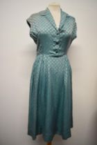 A late 1940s/early 50s day dress of sea foam green medium weight silk, having gathers to the