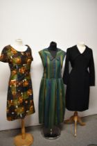 Three vintage 1950s nd 1960s dresses, including abstract floral cotton dress in autumnal tones and