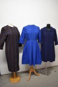 Three vintage dresses, including two 1960s shift dresses and a blue 1950s day dress with pleated