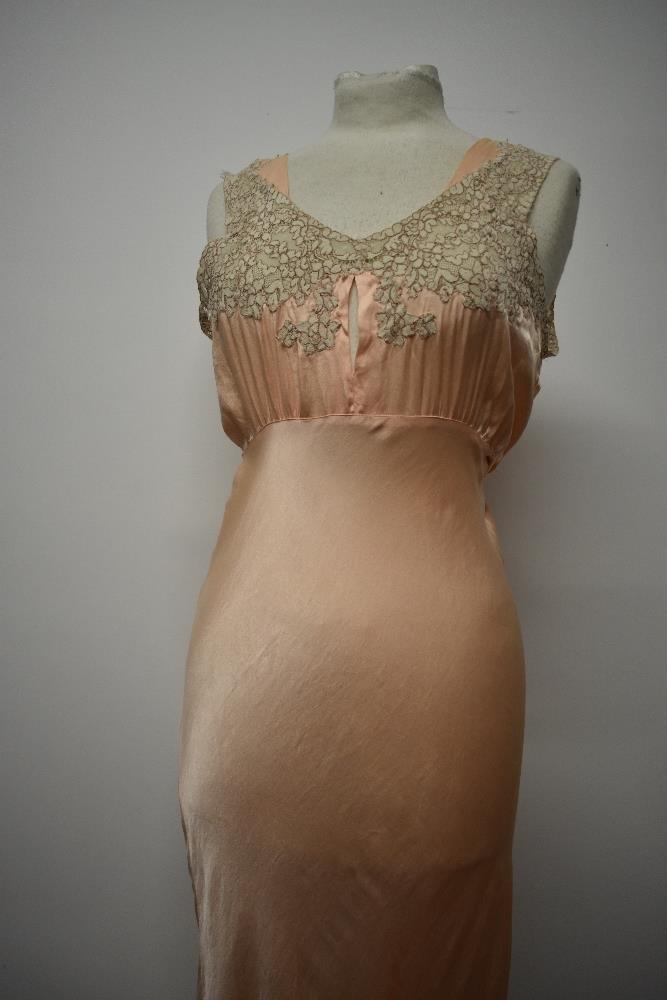 An Art Deco pale pink bias cut nightdress, having beautiful lace to bodice and hem, tie fastening to - Image 2 of 14