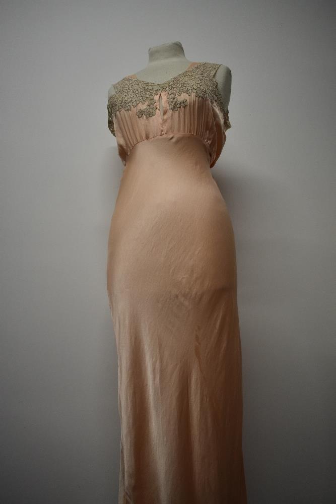 An Art Deco pale pink bias cut nightdress, having beautiful lace to bodice and hem, tie fastening to - Image 8 of 14