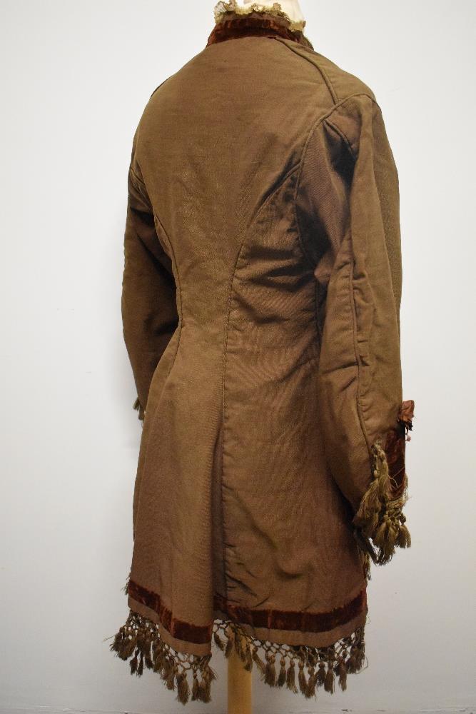 A Brown Victorian overcoat, having velvet trim, tassels to hem and sleeves and silk bow details ( - Image 15 of 17