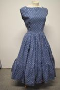 A 1940s/50s cotton day dress, in corn flower blue with tiered skirt and side metal zip, some nipping
