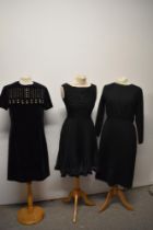 Three vintage 1960s black dresses.