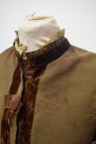 A Brown Victorian overcoat, having velvet trim, tassels to hem and sleeves and silk bow details (