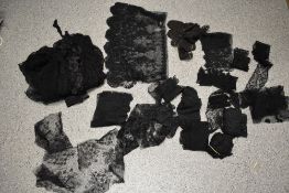 A collection of remnants of vintage and antique black lace and crochet, some have been removed off