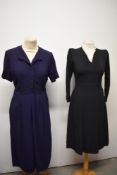 Two 1940s dresses, one black crepe with v neckline edged in white lace and the other navy blue