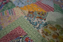A vintage unfinished / unbacked patchwork coverlet, using bright floral and patterned fabric (