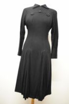 A stunning 1940s black wool day dress, having gathers of pleats to skirt with embroidered arrows,