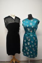 A 1950s emerald green dress with matching belt and a 1950s black velvet dress with contrasting