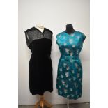 A 1950s emerald green dress with matching belt and a 1950s black velvet dress with contrasting