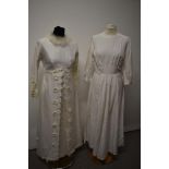 Two vintage wedding dresses, one having appliqué flowers and feather collar.