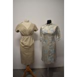 Two 1960s day dresses, including beige dress with pleated bodice and dove grey dress with blossom