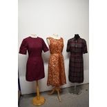 Three vintage 1950s to 1960s dresses, including plaid cotton in a larger size, with belt.