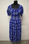 A Royal blue 1940s cotton day dress, having cheerful pattern of baskets of flowers, side metal zip
