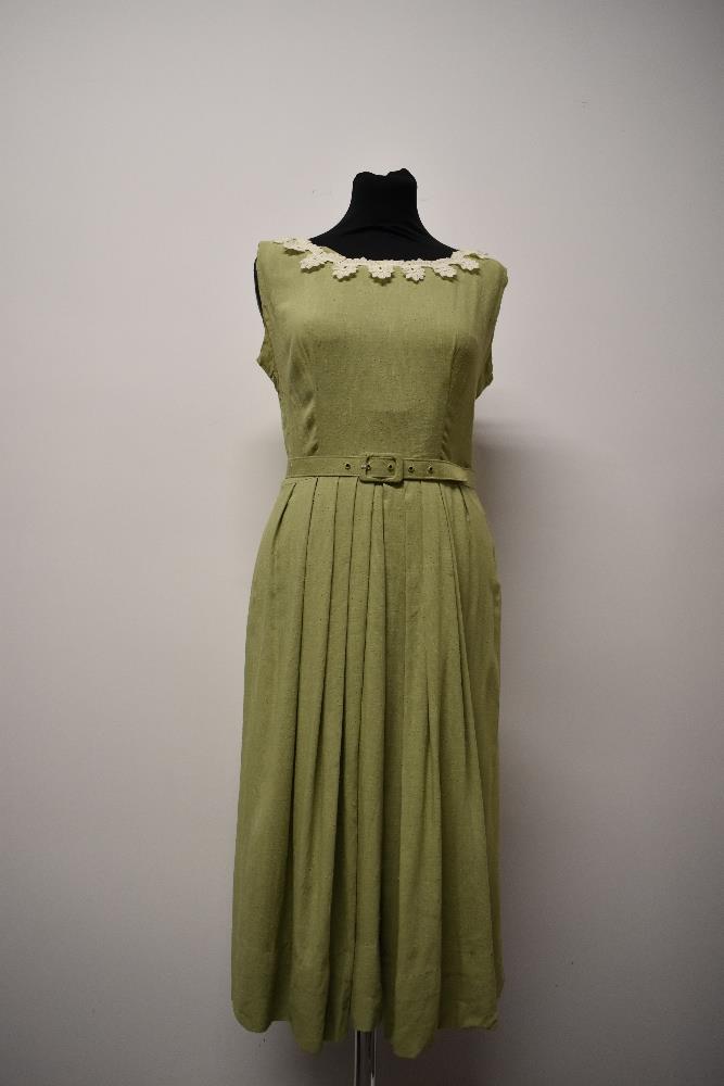 An early 1950s pistachio green slub linen or linen blend day dress, having pleated skirt, boat