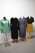 A mixed lot of vintage dresses, blouses and a skirt, varying eras and styles.