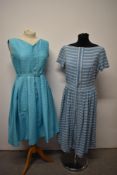 Two vintage 1950s cotton sundresses, including one of textured cotton with pleated skirt, belt to