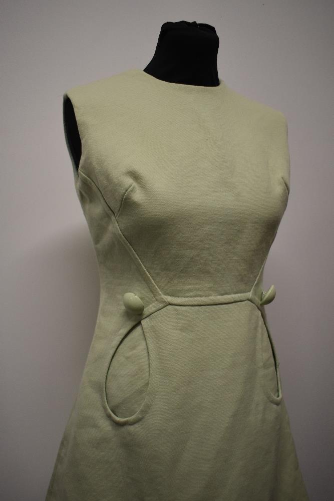 A mint green 1960s mini dress, with looped pockets and large button detail. - Image 3 of 8