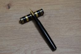 A Mabie Todd & Co Swan 192/32 lever fill fountain pen in black with several decorative bands to