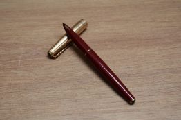 A Parker 65 capillary fill fountain pen in red with rolled gold cap. Boxed