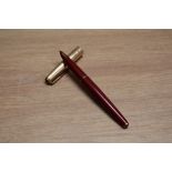 A Parker 65 capillary fill fountain pen in red with rolled gold cap. Boxed