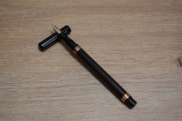 A De La Rue Onoto plunger fill fountain pen in BHR with gold band to the top and bottom of the