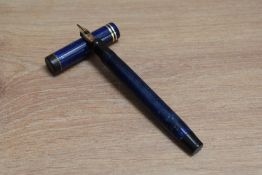 A Parker Duofold Special Lucky Curve button fill fountain pen in lapis lazuli blue with white flecks