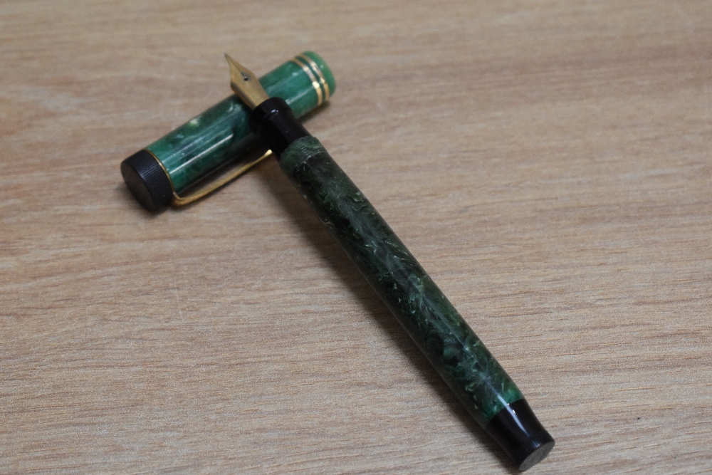 A Parker Duofold Special Lucky Curve button fill fountain pen in jade green with two narrow bands to