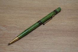 A Mabie Todd Swan propelling pencil with two gold on black band (142/50) in jade green