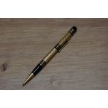 A Mabie Todd & Co Fyne Poynt propelling pencil set in black with gold overlay and several decorative