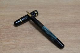 A Pelikan 100N piston fill fountain pen in green and black with two narrow rings to the cap having