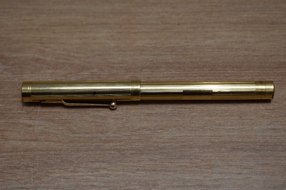 A Mabie Todd Self Filling lever fill fountain pen in yellow metal in engine turned reeded design - Image 3 of 3