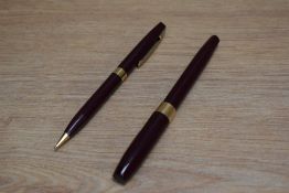 A Sheaffer Imperial IV Touchdown plunger fill fountain pen and propelling pencil set in burgundy