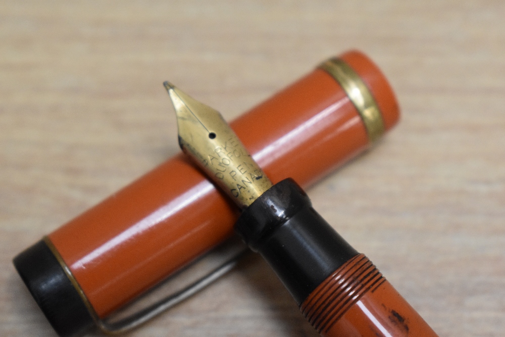 A Parker Duofold Special Lucky Curve button fill fountain pen in orange with raised band to the - Image 2 of 3