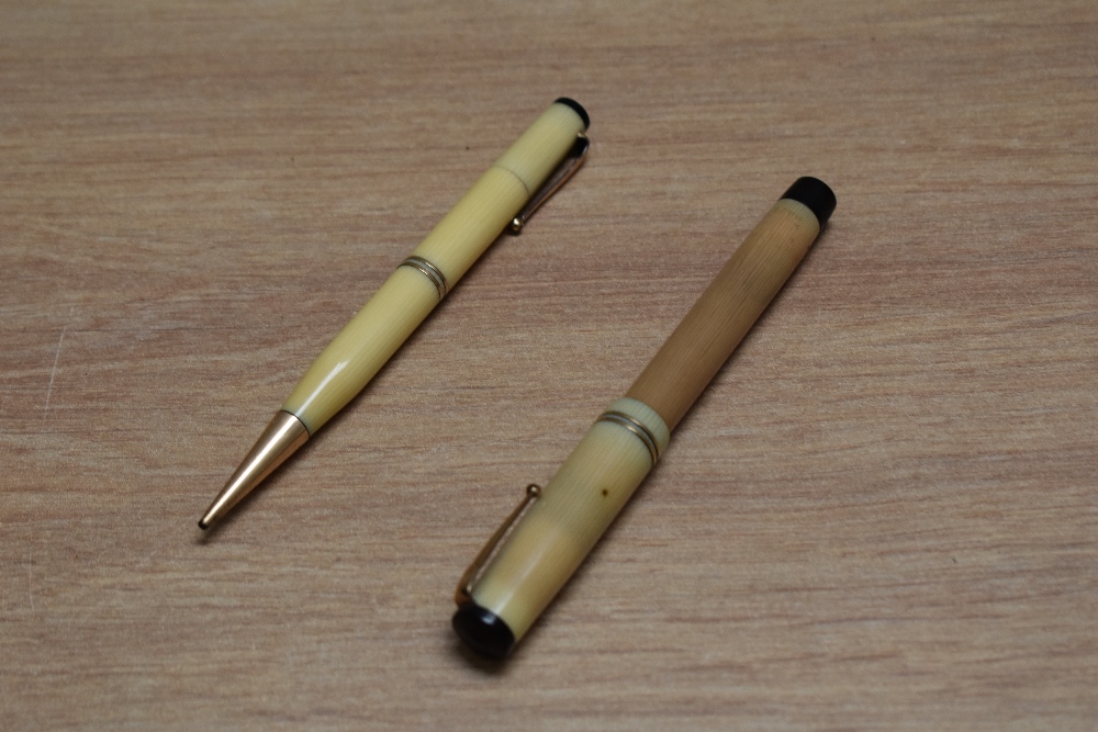 A Mabie Todd & Co Swan lady twist fill fountain pen and propelling pencil set in onyx with two