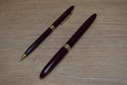 A Sheaffer Touchdown Sovereign pundger fill fountain pen and propelling pencil set in burgundy