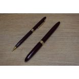 A Sheaffer Touchdown Sovereign pundger fill fountain pen and propelling pencil set in burgundy