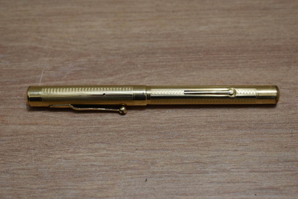 A Mabie Todd Self Filling lever fill fountain pen in yellow metal in engine turned wave design - Image 3 of 3